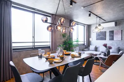 a dining room with a table and chairs at Camo's Tokyo Oshiage in Tokyo