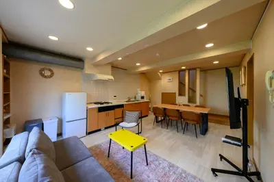 a living room with a couch and a kitchen at Direct to Skytree Asakusa 6min Walk to Station A162 in Tokyo