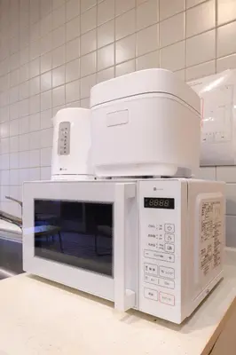 a white microwave oven sitting on top of a counter at Direct to Skytree Asakusa 6min Walk to Station A162 in Tokyo