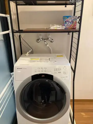 a washing machine in a laundry room with a shelf at Direct to Skytree Asakusa 6min Walk to Station A162 in Tokyo