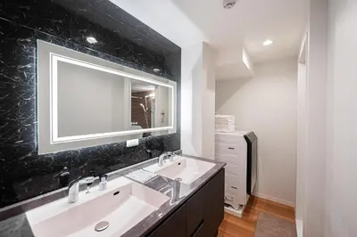 a bathroom with two sinks and a mirror at Shinjuku SAIEI Hotel 201 in Tokyo
