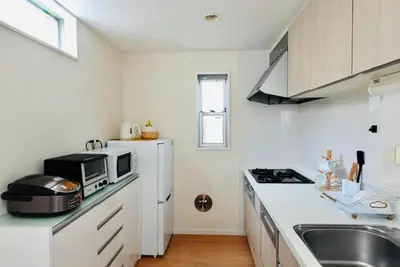 a white kitchen with a sink and a microwave at \u6674Hare Hotel in Tokyo