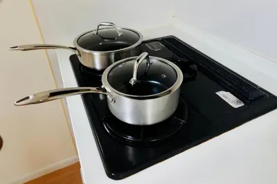 two pots sitting on top of a stove at \u6674Hare Hotel in Tokyo