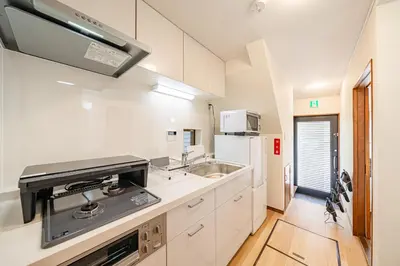 a white kitchen with a sink and a microwave at #36 -\u5e02\u8c37\u52a0\u8cc0\u753a- Entire House in Tokyo