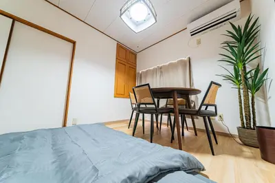 a bedroom with a bed and a table and chairs at #36 -\u5e02\u8c37\u52a0\u8cc0\u753a- Entire House in Tokyo