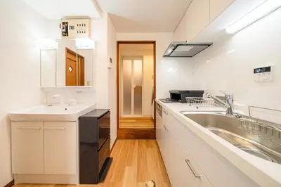 a large white kitchen with a sink and a counter at #36 -\u5e02\u8c37\u52a0\u8cc0\u753a- Entire House in Tokyo