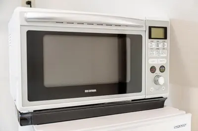 a microwave oven sitting on top of a refrigerator at #36 -\u5e02\u8c37\u52a0\u8cc0\u753a- Entire House in Tokyo