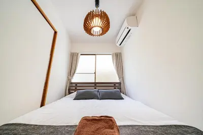 a small bedroom with a bed with a window at #36 -\u5e02\u8c37\u52a0\u8cc0\u753a- Entire House in Tokyo