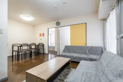 a living room with a couch and a table at tokyo mirai 3F in Tokyo