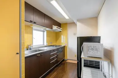 a small kitchen with a sink and a refrigerator at tokyo mirai 3F in Tokyo
