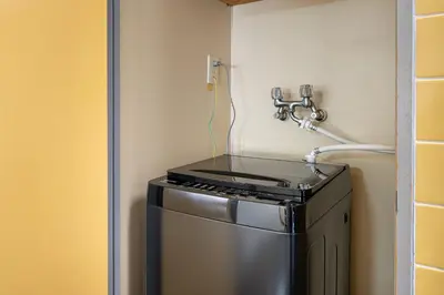 a small stove in a kitchen with a wall at tokyo mirai 3F in Tokyo