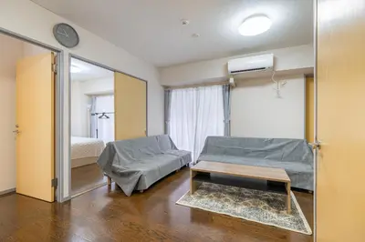 a living room with a bed and a mirror at tokyo mirai 3F in Tokyo