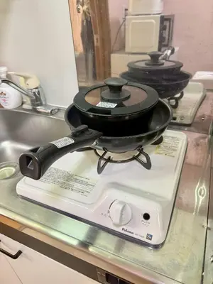 a pot on top of a scale on a kitchen counter at Tokyo Stay Ikebukuro East in Tokyo