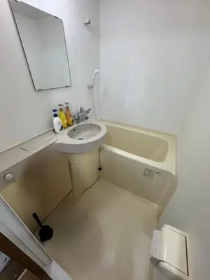 a white bathroom with a sink and a mirror at Tokyo Stay Ikebukuro East in Tokyo