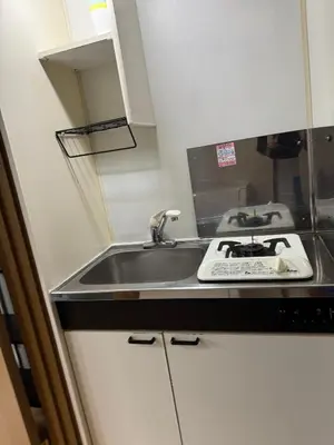 a kitchen counter with a sink and a stove at Tokyo Stay Ikebukuro East in Tokyo