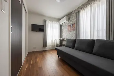 a living room with a couch and a table at self-check in HomeNest Akihabara in Tokyo