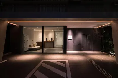 a room with a large glass door in a building at Cava House in Tokyo
