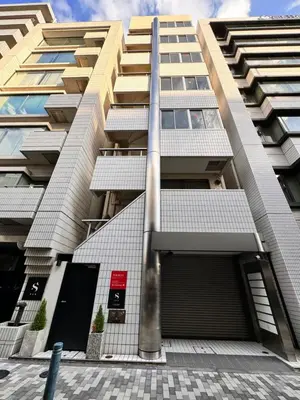 a tall building with a parking garage in front of it at Visionary Stay HINODE in Tokyo