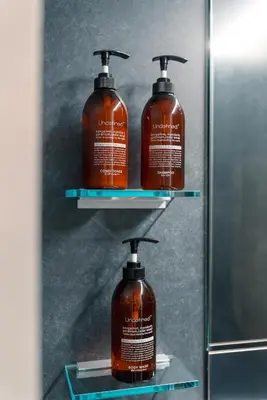 two bottles of soap on display in a mirror at Visionary Stay HINODE in Tokyo