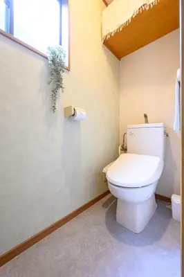 a bathroom with a white toilet in a room at Nico Galleria Ōyama in Tokyo