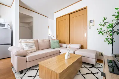 a living room with a couch and a coffee table at Nico Galleria Ōyama in Tokyo