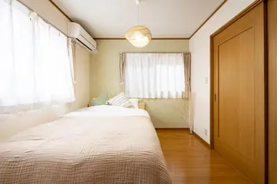 a bedroom with a bed and a large window at Nico Galleria Ōyama in Tokyo