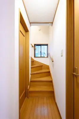 a hallway with wooden stairs in a house at Nico Galleria Ōyama in Tokyo