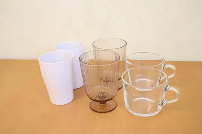 four glass vases and cups sitting on a table at Nico Galleria Ōyama in Tokyo