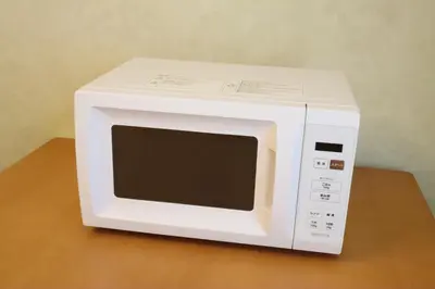 a white microwave oven sitting on top of a table at Nico Galleria Ōyama in Tokyo