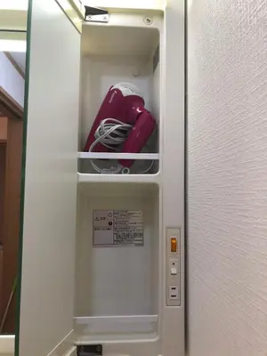 a refrigerator with its door open with a red object inside at Joy \u62bc\u4e0a\u4e00\u6237\u5efa in Tokyo