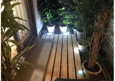 a porch with potted plants and a wooden bench at Joy \u62bc\u4e0a\u4e00\u6237\u5efa in Tokyo