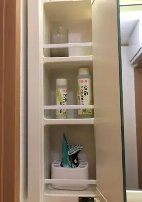 a white cupboard with some medicines in it at Joy \u62bc\u4e0a\u4e00\u6237\u5efa in Tokyo