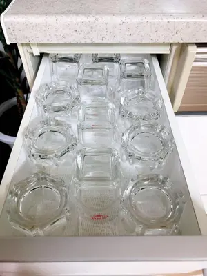 a drawer filled with empty glasses on a counter at Joy \u62bc\u4e0a\u4e00\u6237\u5efa in Tokyo
