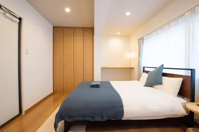 a bedroom with a large bed and a window at Higashi-Ikebukuro-5dk-TS0456 in Tokyo