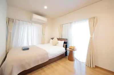 a bedroom with a bed and a large window at Higashi-Ikebukuro-5dk-TS0456 in Tokyo