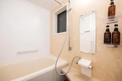 a bathroom with a bath tub and a mirror at Higashi-Ikebukuro-5dk-TS0456 in Tokyo