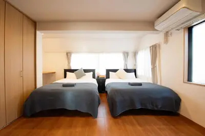 two beds sitting next to each other in a bedroom at Higashi-Ikebukuro-5dk-TS0456 in Tokyo