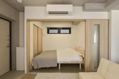 a small bedroom with a bed and a window at Bldg E Tokyo in Tokyo