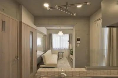 a living room with a bed and a bathroom at Bldg E Tokyo in Tokyo
