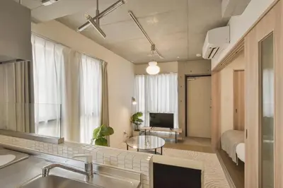 a kitchen and living room with a sink and a mirror at Bldg E Tokyo in Tokyo