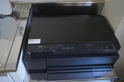 a black printer sitting on top of a shelf at Wonderful stay TOKYO KURAMAE in Tokyo