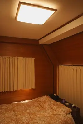a bedroom with a bed and a light on the ceiling at Wonderful stay TOKYO KURAMAE in Tokyo