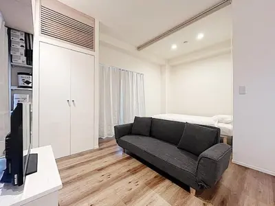 a living room with a couch and a bed at Tokyo Stay GB Sugamo in Tokyo