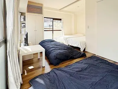 a bedroom with a bed and a desk and a sink at Tokyo Stay GB Sugamo in Tokyo