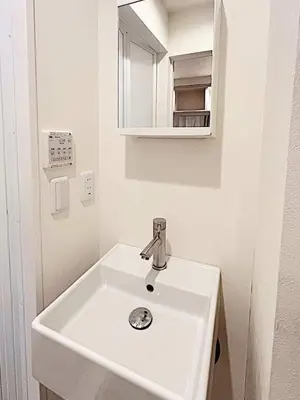 a bathroom with a white sink and a mirror at Tokyo Stay GB Sugamo in Tokyo