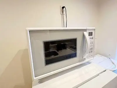 a microwave oven sitting on top of a table at Tokyo Stay GB Sugamo in Tokyo