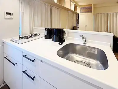 a kitchen counter with a sink and a stove at Tokyo Stay GB Sugamo in Tokyo