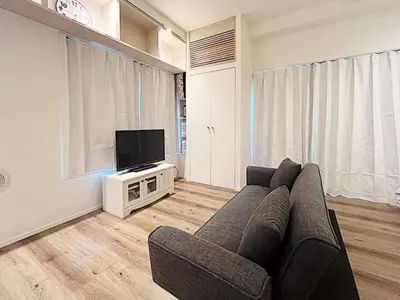 a living room with a couch and a flat screen tv at Tokyo Stay GB Sugamo in Tokyo
