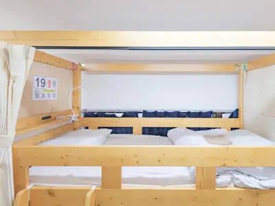 a bunk bed in a small room with at Dormitory \u30b5\u30fc\u30af\u30eb\u30c6\u30f3- Share Room For Male Only \u7537\u6027\u5c02\u7528\u30c9\u30df\u30c8\u30ea\u30fc in Tokyo