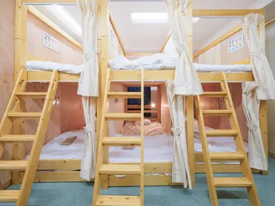 a bunk bed in a room with two bunk beds at Dormitory \u30b5\u30fc\u30af\u30eb\u30c6\u30f3- Share Room For Male Only \u7537\u6027\u5c02\u7528\u30c9\u30df\u30c8\u30ea\u30fc in Tokyo